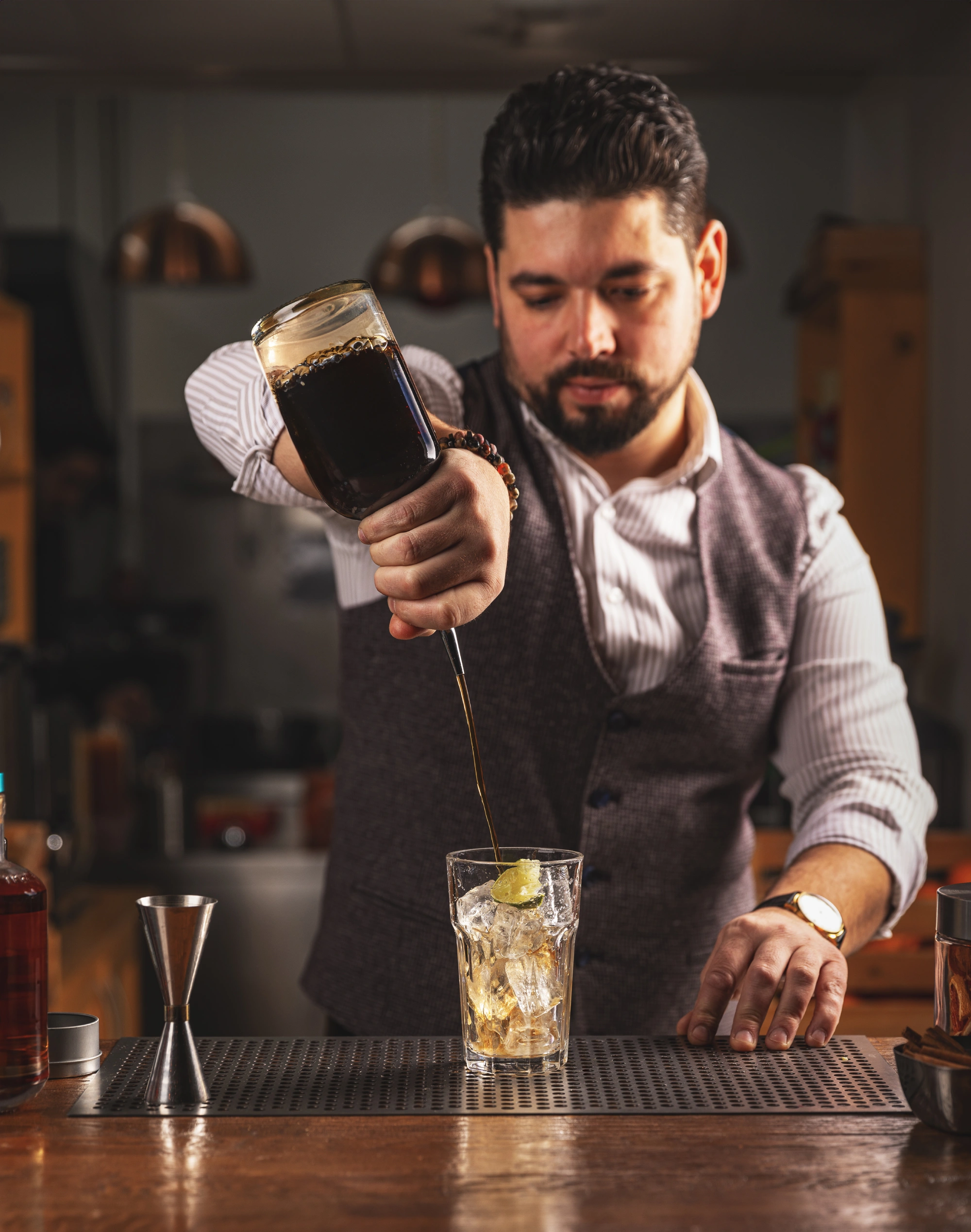 bartender-pouring-craft-cocktail-bar.webp